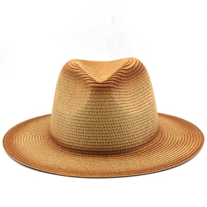 Detail of hand-woven fedora straw hat with gradient brown finish and wide brim