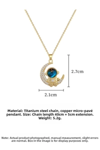 Close-up of astronaut and moon pendant with detailed dimensions 2.7cm by 2.1cm