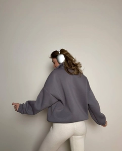 Back view of grey-purple half-zip sports sweatshirt showing oversized fit and soft texture
