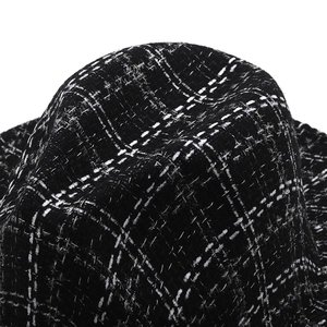 Close-up of British style houndstooth wool fedora hat top with metallic thread detail