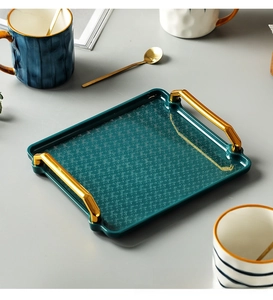Modern emerald green ceramic tray with gold handles and elegant ripple pattern