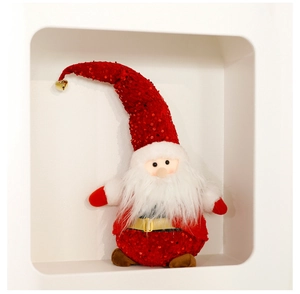 Detail of red sequined Santa Claus plush with white beard and gold bell decorations