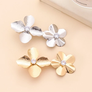 Elegant gold and silver metallic flower hair clips with sparkling crystal centers