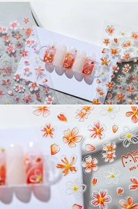 Macro detail of 3D embossed cherry blossom nail stickers with pink gradient petals