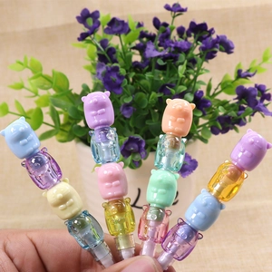 Close-up of four colorful stacking pencils with cartoon bears and transparent sections