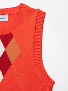 Detailed view of rib-knit round neckline and classic argyle pattern on orange vest