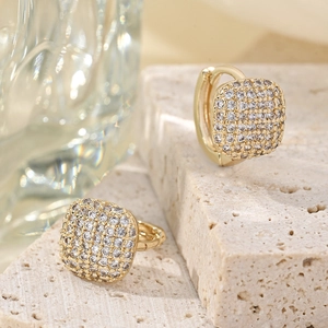 Detailed close-up of 14K gold-plated hoop earrings with micro-pave cubic zirconia crystals
