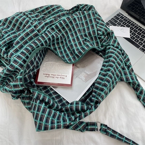 Hobo tote bag showing spacious interior with green plaid pattern and laptop storage