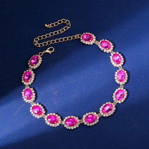 Detailed macro view of vibrant rose red crystal necklace with gold plated chain links