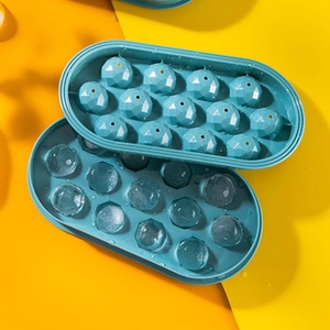 Detailed view of teal diamond-shaped ice mold with twelve spherical compartments