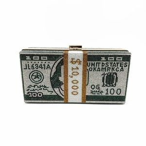 Macro view of crystal-encrusted evening clutch with 100 dollar bill pattern and silver rhinestones