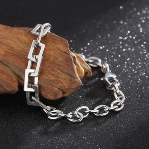 Macro view of industrial stainless steel curb chain with rectangle links and lobster clasp