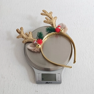 Detail showing the lightweight 23.3g Christmas antler headband with sequins and bells