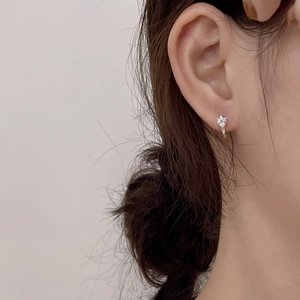 Close-up of a minimalist S925 sterling silver hoop earring with a sparkling zircon stone