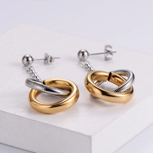 Minimalist interlocked gold and silver two-tone hoop earrings with textured metal finish