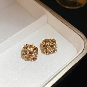 Champagne crystal pave square stud earrings with gold plating shown at 45-degree angle