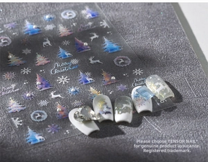 Macro detail of iridescent Christmas nail stickers with reindeer and snowflake patterns
