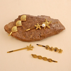 5-piece gold ocean theme hair clip set featuring seashell and starfish with pearl accents