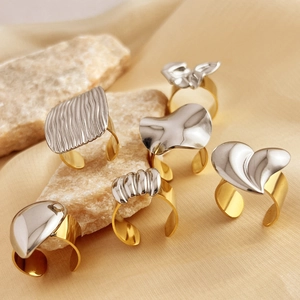 Modern two-tone mixed metal liquid style rings in gold and silver open adjustable designs