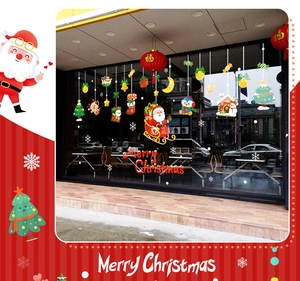 Detail of Santa Claus and reindeer window stickers with Merry Christmas text on a shop window