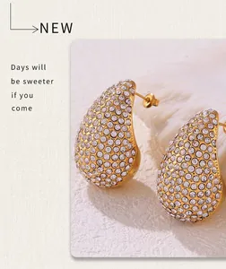 Detail of 18K gold plated teardrop earrings with full pavé crystal stones for women