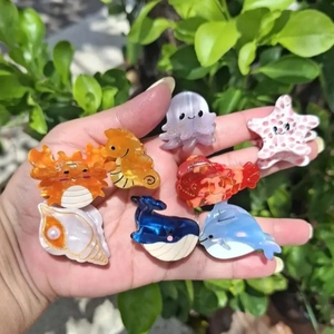 Colorful resin ocean animal hair clips featuring crab, seahorse, and starfish designs