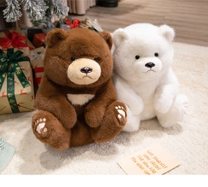 Close-up of soft plush teddy bears in brown and white with festive holiday background