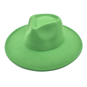 Top-down view of bright green wool felt wide brim fedora hat with classic teardrop crown