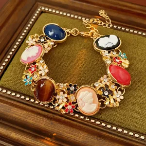 Vintage gold-toned floral bracelet with colorful enamel cameos and crystals on velvet