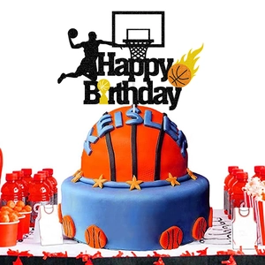 Close-up of basketball-themed cake topper with Happy Birthday sign and athlete silhouette