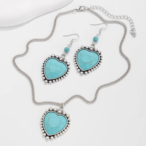 Detail shot of boho silver heart necklace and earrings set with blue turquoise stones