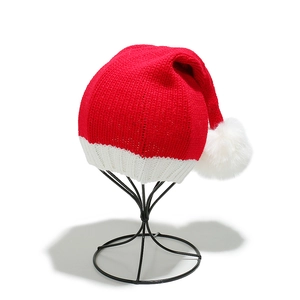 Detailed view of the red and white chunky knit texture on the Christmas Santa long tail hat
