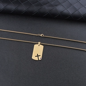 Close-up of golden stainless steel dog tag necklace with hollow cross and blue zircon