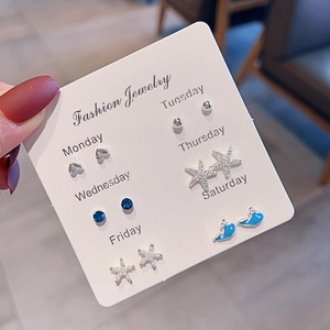 Close-up of a 7-pair S925 silver stud earring set with heart, star and dolphin designs