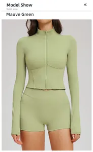 Detail of sage green yoga set with zip-up long sleeve top and high-waist shorts