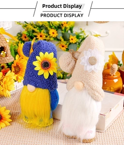 Detail of plush gnome set with sunflower hats on a rustic floral background