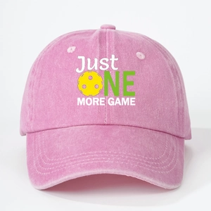 Pink washed cotton baseball cap with JUST ONE MORE GAME pickleball print on white background