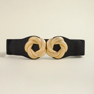 Macro shot of the interlocking golden knot buckle on a black elastic vintage corset belt