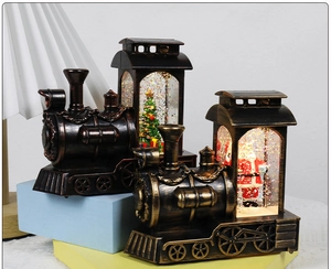 Detail of vintage Christmas train snow globes featuring Santa and a tree inside