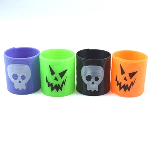 Set of four Halloween plastic slinky toys with spooky skull and pumpkin face patterns