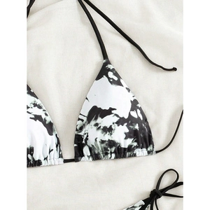 Detailed view of the black and white tie-dye bikini top with triangle lace-up straps
