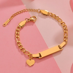 Detail of golden stainless steel ID bracelet with heart pendant on pink background