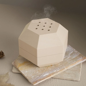 Minimalist octagonal ceramic incense burner with a 9-hole lid in a natural Zen setting