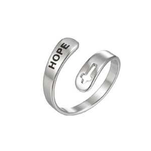 Detail of adjustable silver ring featuring a hollow cross design and engraved HOPE text