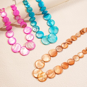 Colorful bohemian style necklace with round gradient shell beads in three vibrant colors