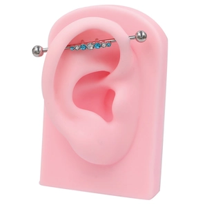 Piercing industriel en acier poli orné de zircons marquise bleus et blancs brillants