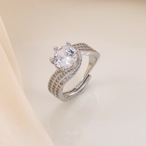 Close-up of silver open ring featuring a large round zircon and multi-row side diamonds