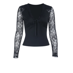 Close-up of elegant V-neckline with lace sleeves and front lace-up detail on black top