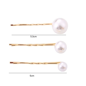 Detail showing 5.3cm and 5cm golden metal hair clips with varying sizes of faux pearls
