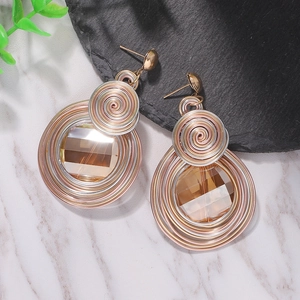 Bohemian wire-wrapped heart pearl drop earrings with amber crystal on marble surface